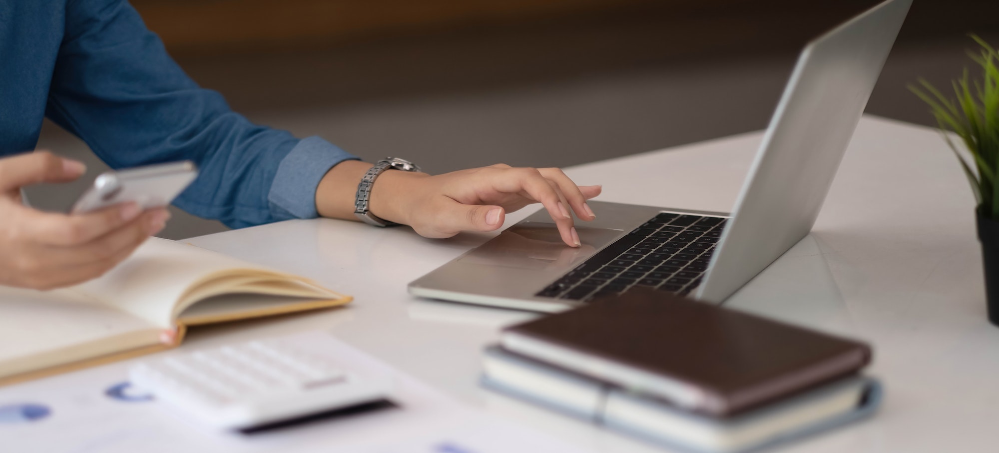 A businesswoman using an online banking program in order to open a digital savings account. The