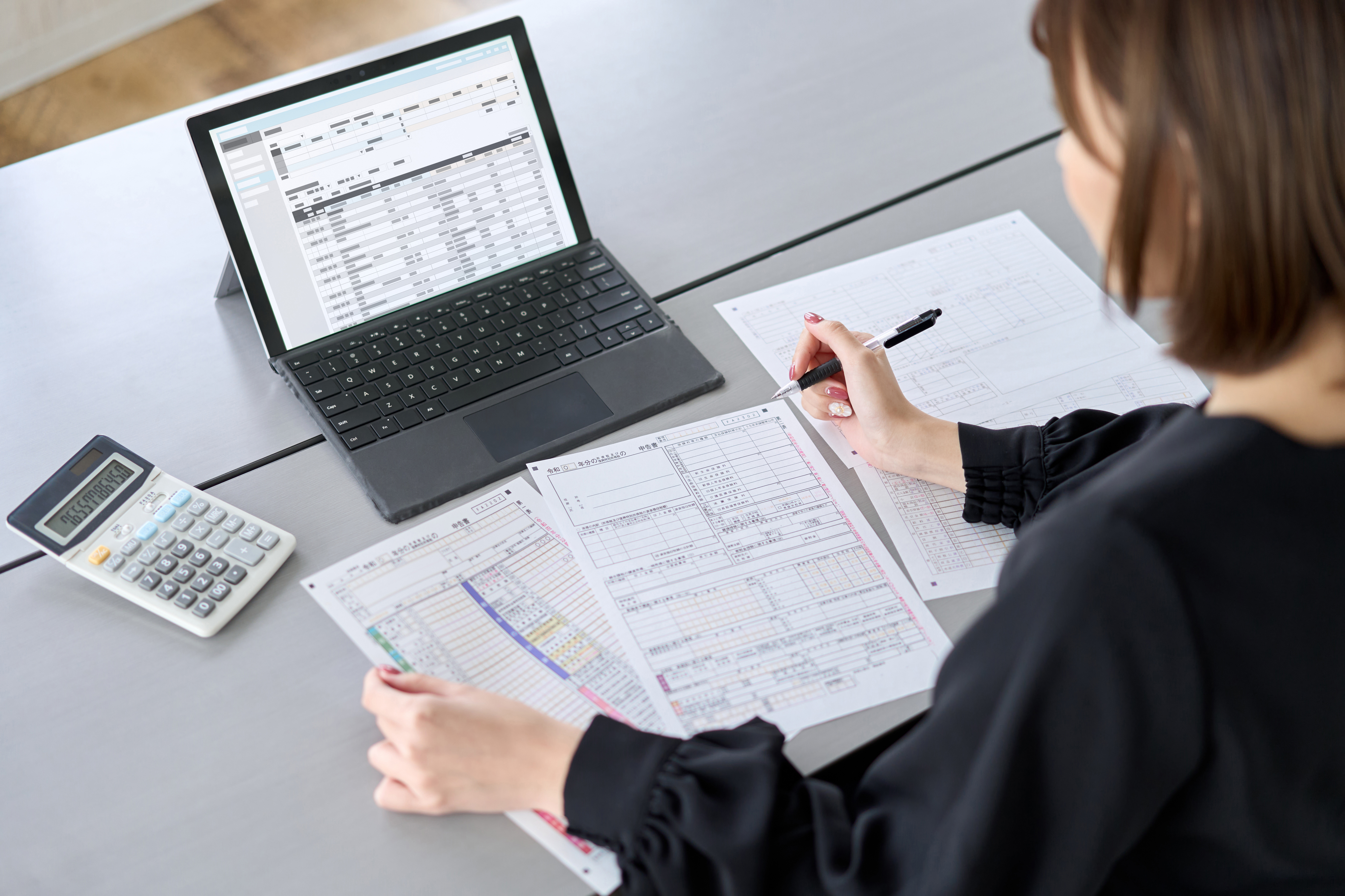 Asian woman preparing tax return documents