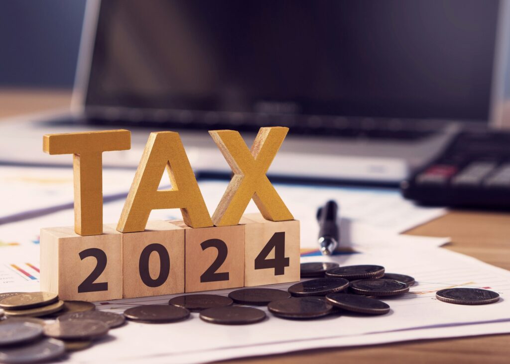 Tax wooden letter and 2024 number on wooden block.Pay tax in 2024 years.