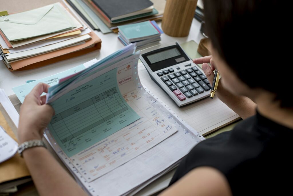 Adult asian woman working on payment bills accounting summary data